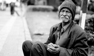 grayscale photography of man sitting